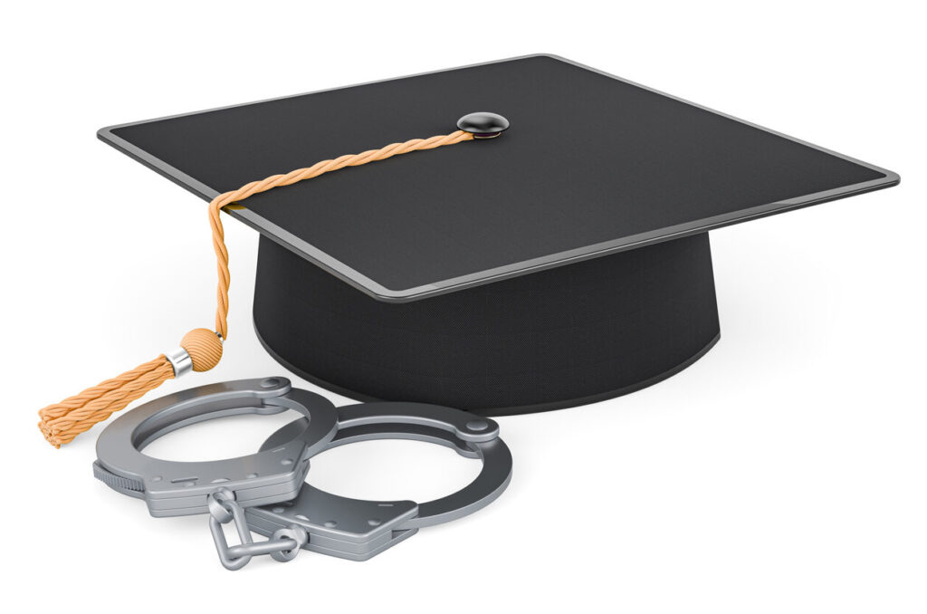 hand cuffs and student graduation hat